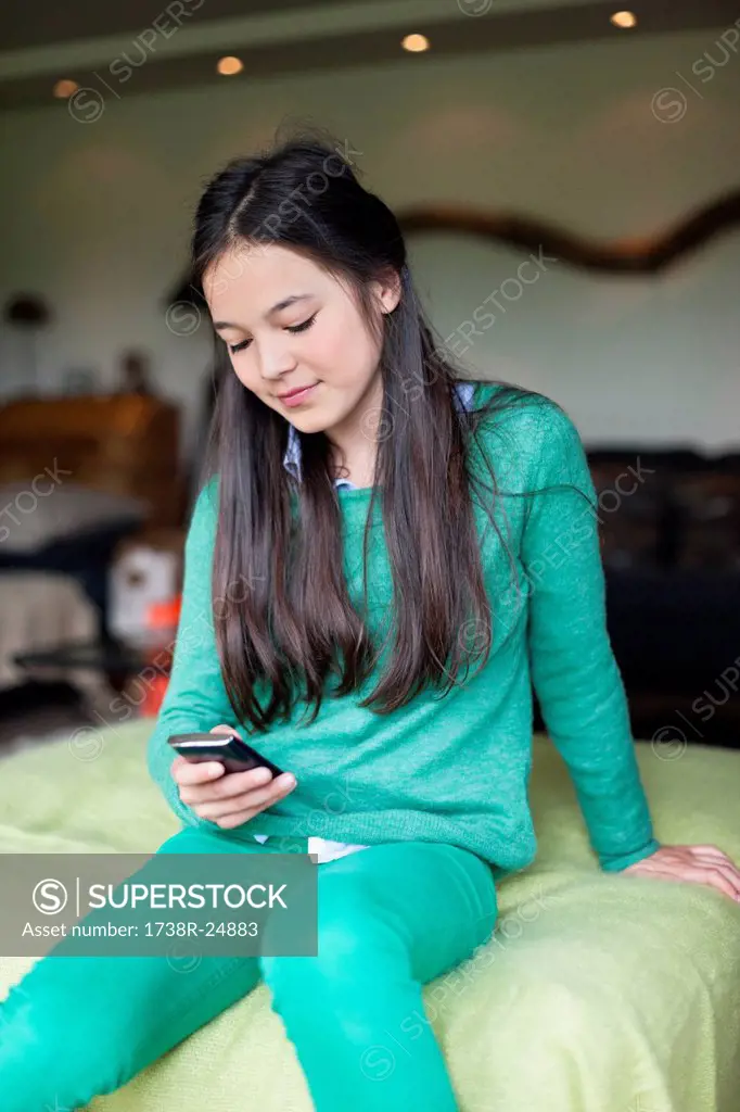 Girl reading sms on a mobile phone