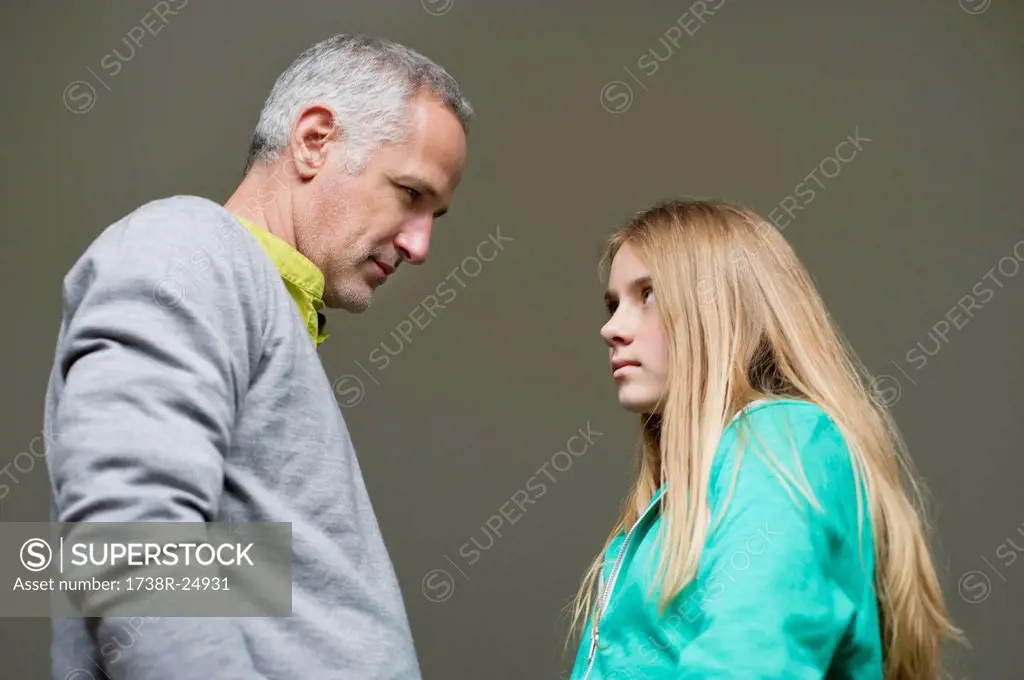 Man and daughter frowning to each other