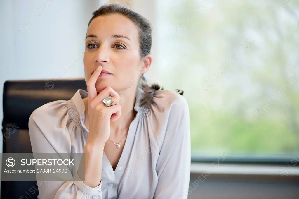 Close_up of a businesswoman thinking in an office