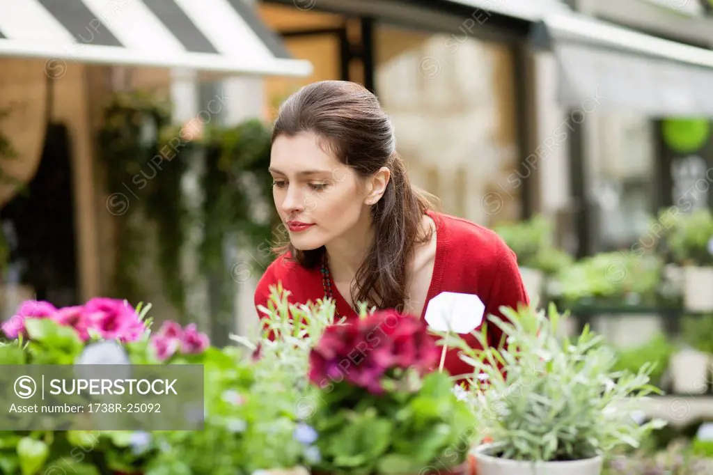 Woman smelling flowers in a flower shop