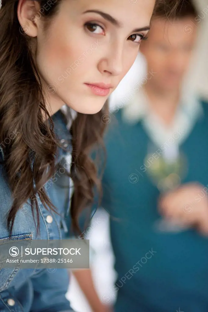 Woman thinking with her husband in the background