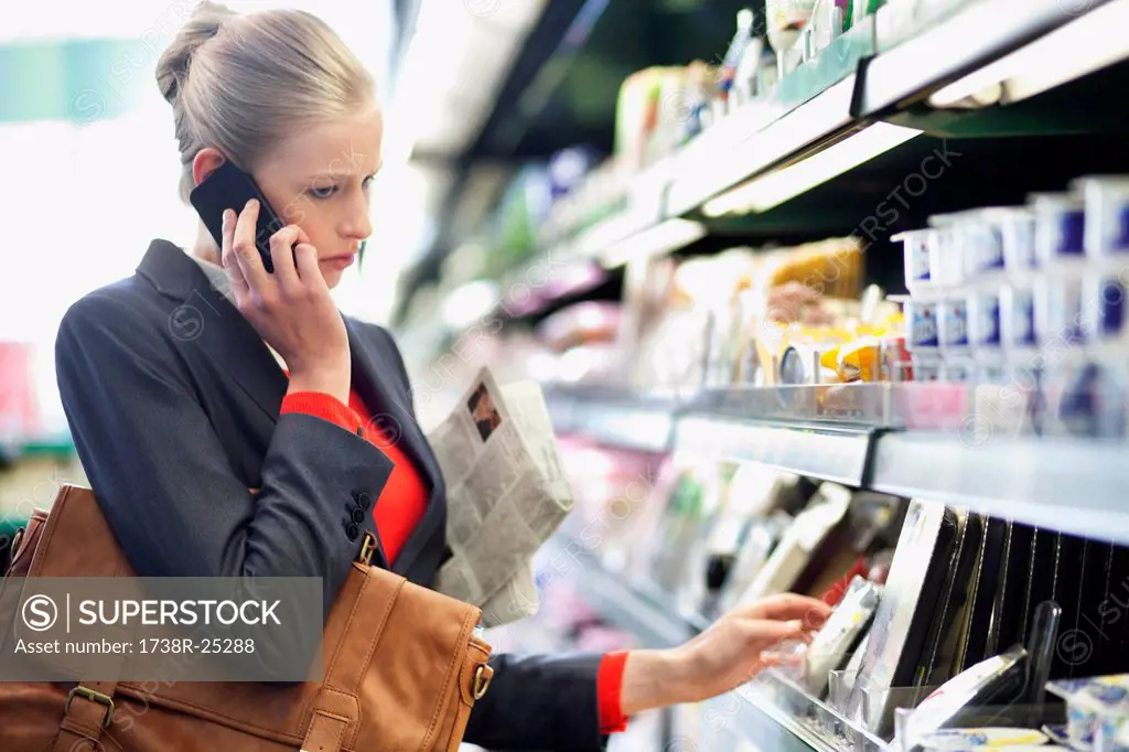 Woman in a supermarket talking on a mobile phone