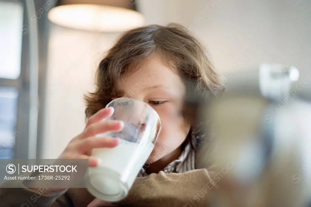 Close_up of a boy drinking a glass of milk