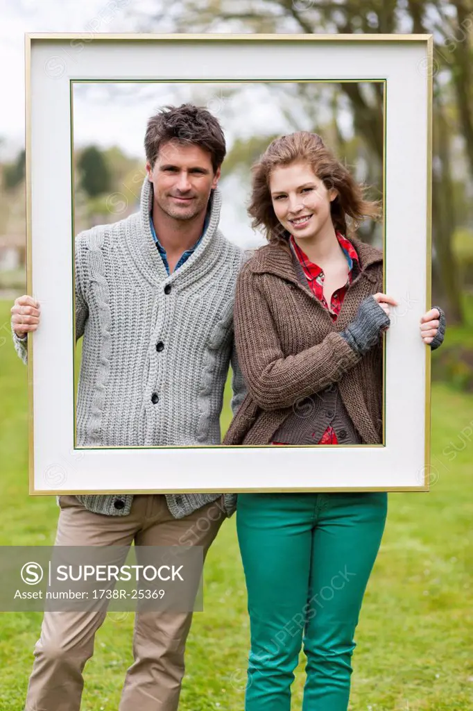 Portrait of a couple holding a frame