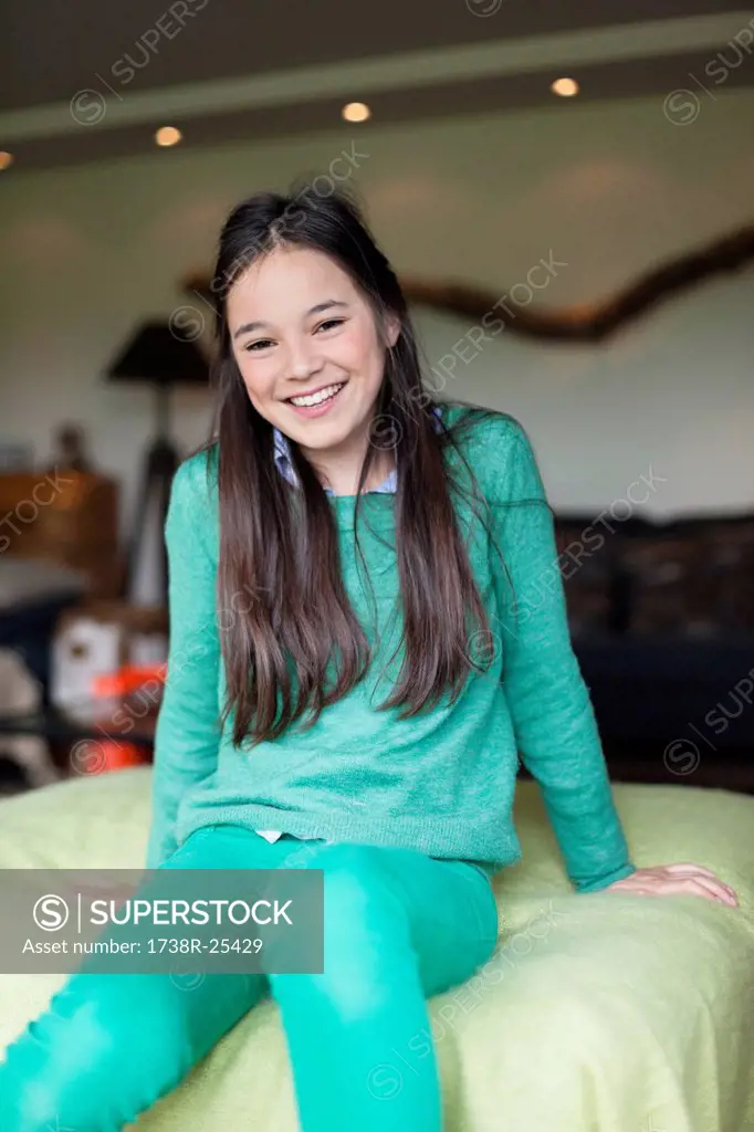 Portrait of a girl sitting on bed