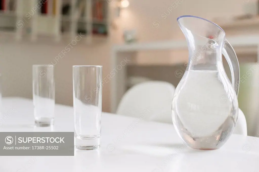 Jug of water and glasses on a dining table