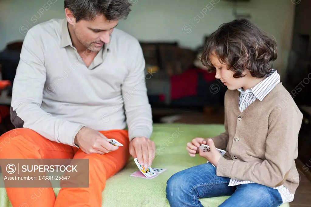 Man playing cards with his son