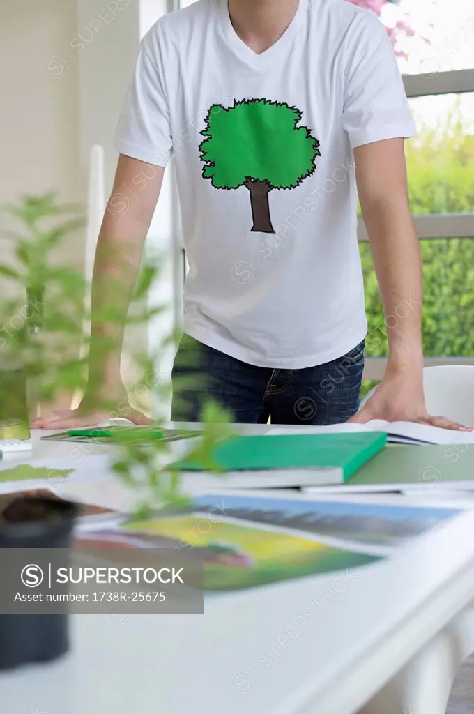 Plant and environmental awareness poster on a table in front of a man