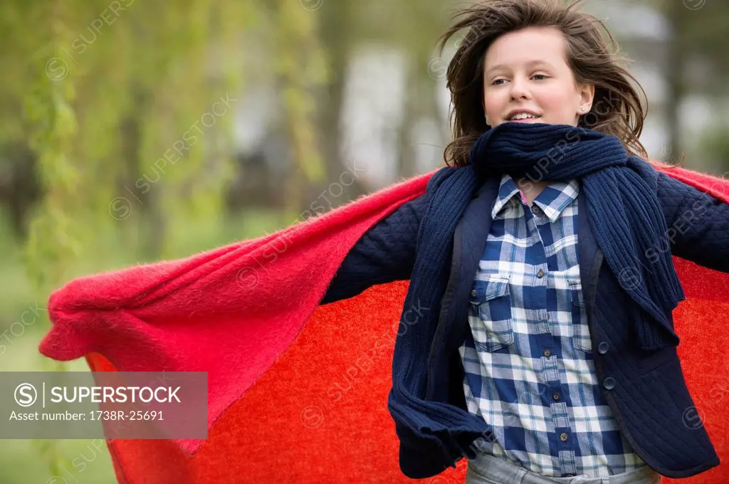 Girl holding a blanket with her arm outstretched