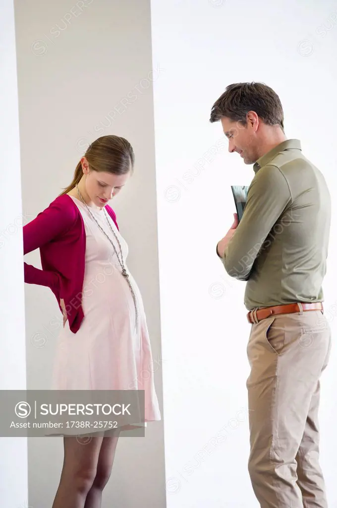 Man looking at a pregnant woman