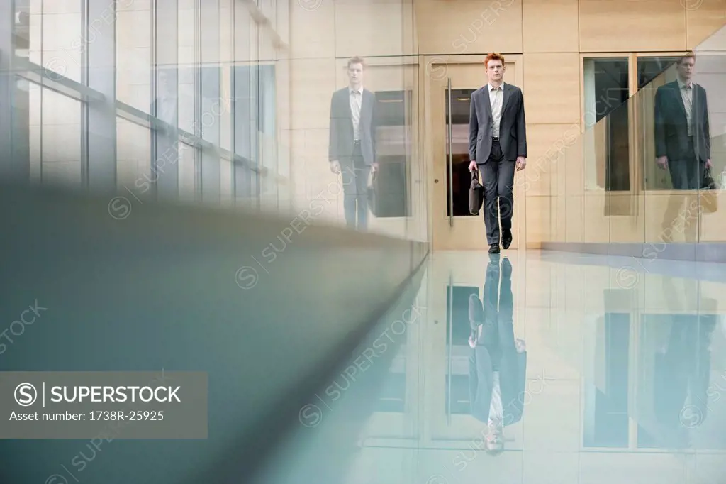 Businessman walking in an office corridor