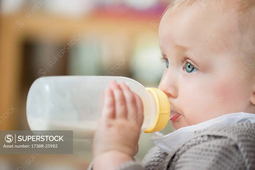 Close_up of a baby girl feeding milk