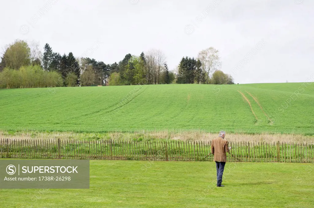 Man using a mobile phone in a field