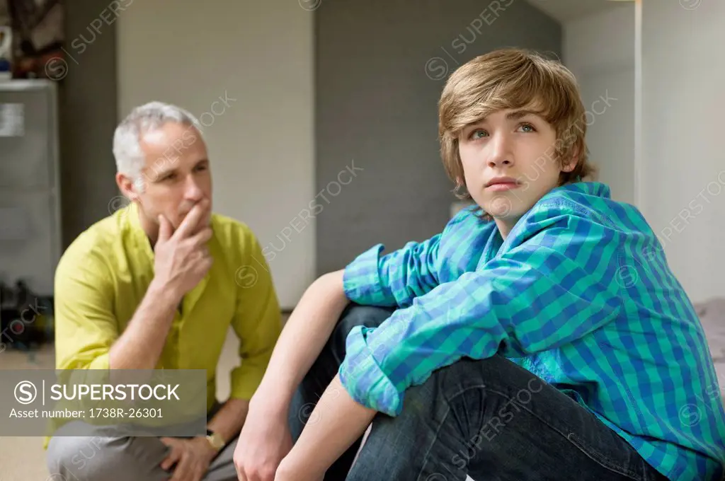 Man sitting with his son looking upset