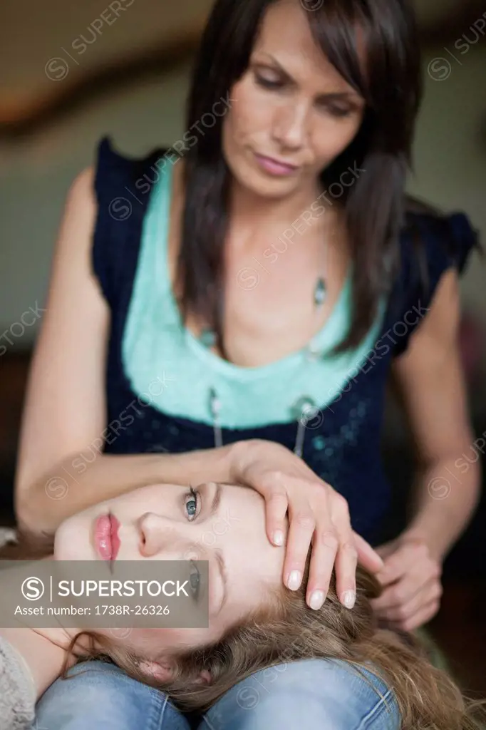 Woman lying on her mother´s lap