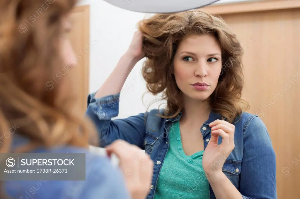Woman examining her hair