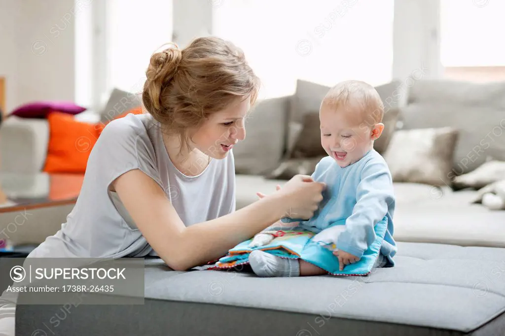 Woman teaching her daughter with a picture book