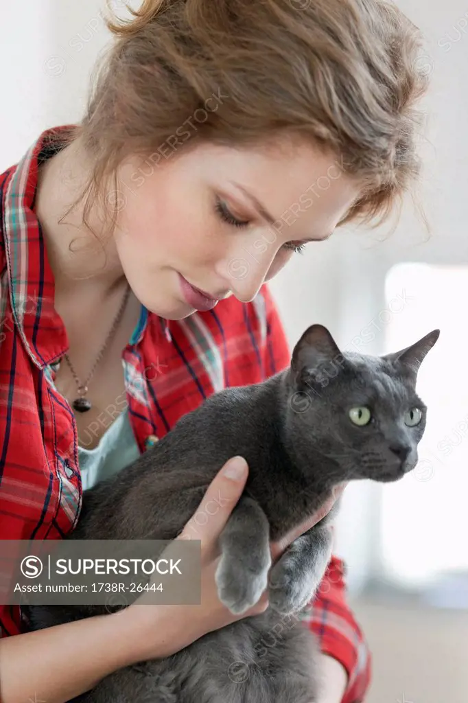 Close_up of a woman holding a black cat