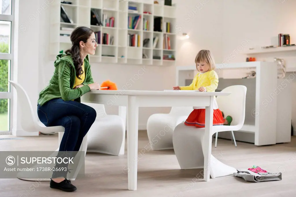 Woman teaching her daughter at home