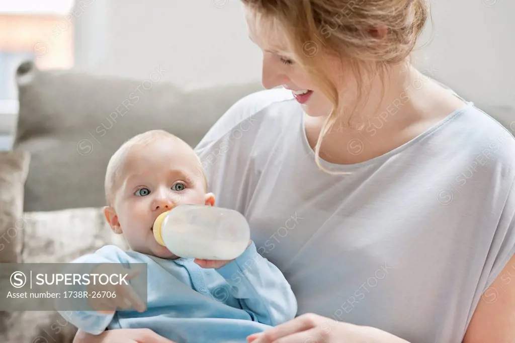 Baby girl feeding on milk with a milk bottle
