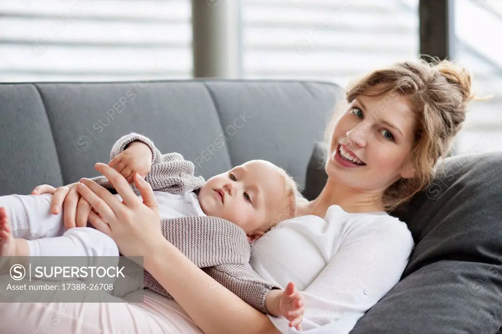Woman resting on a couch with her daughter