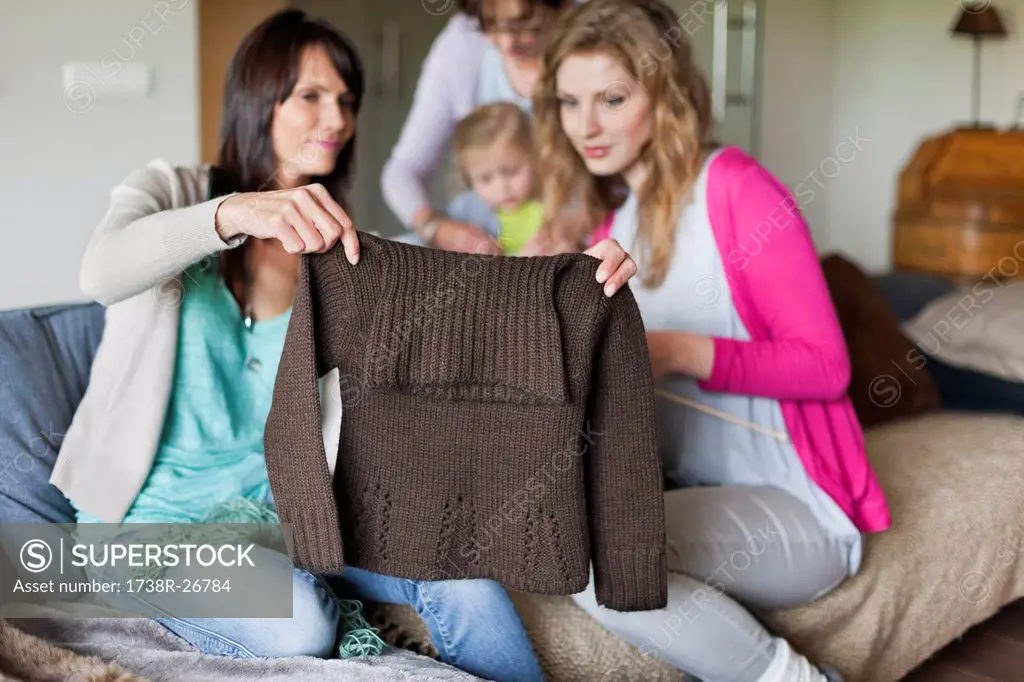 Woman and her daughter looking a sweater