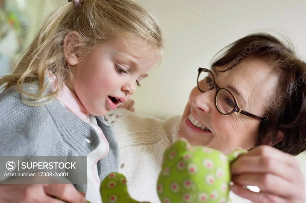 Close_up of a girl playing with her grandmother