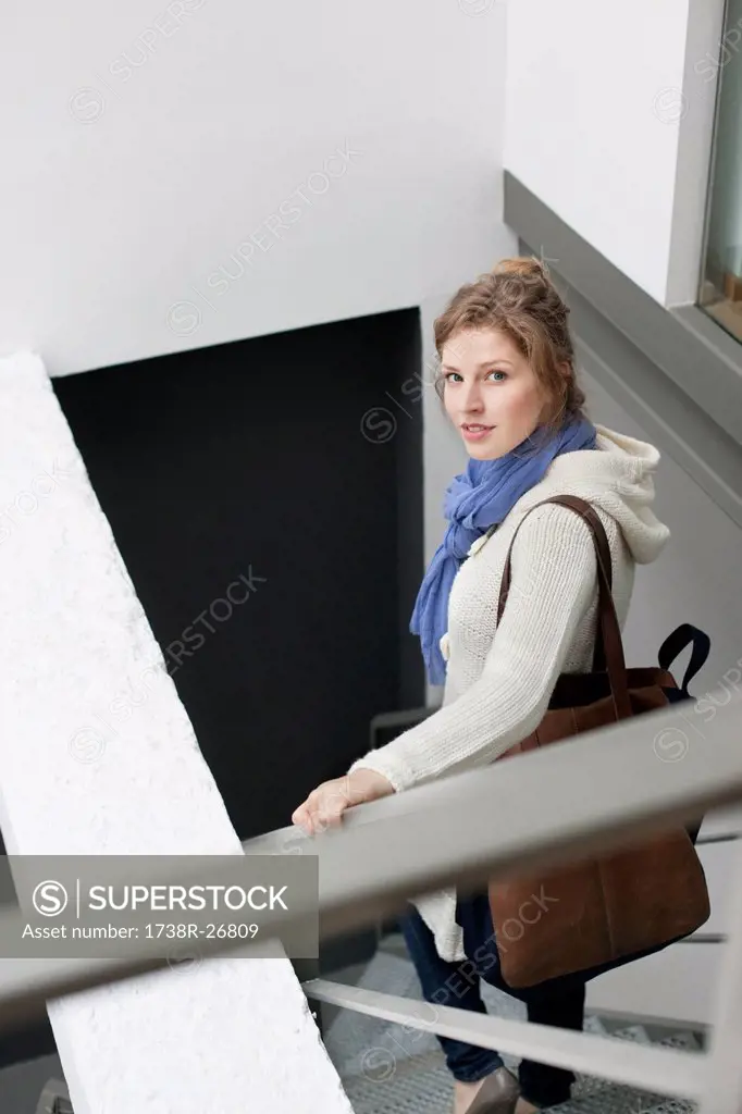 Portrait of a woman moving down stairs