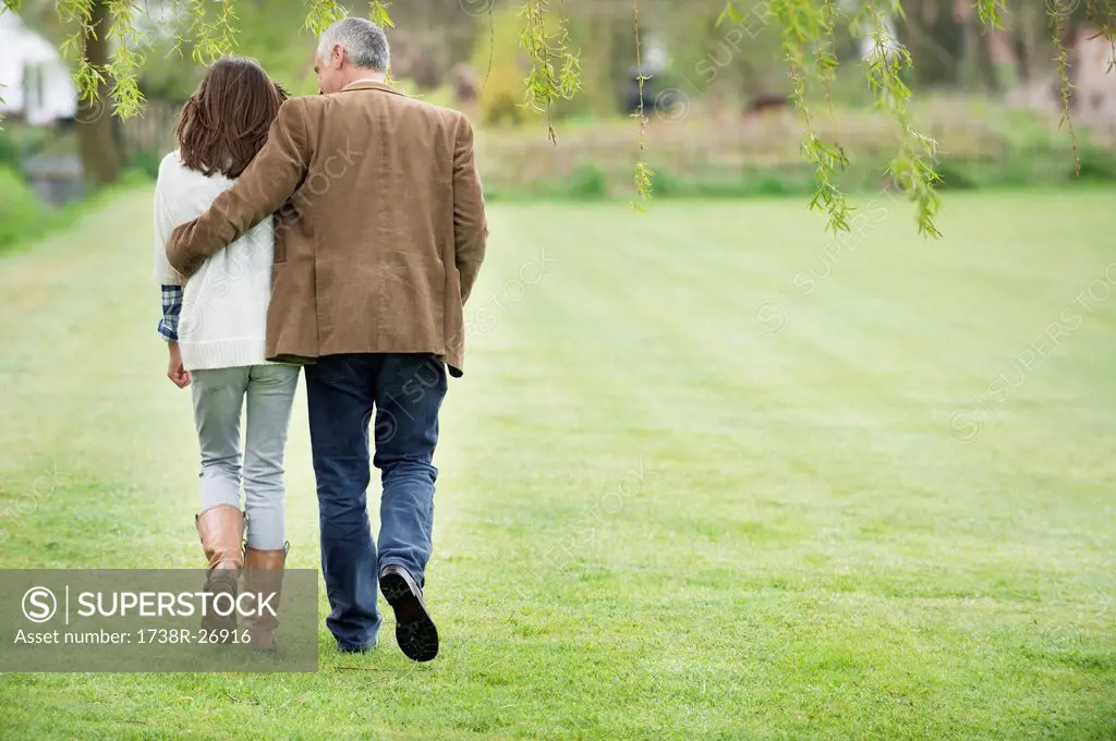 Man walking with his daughter in a park