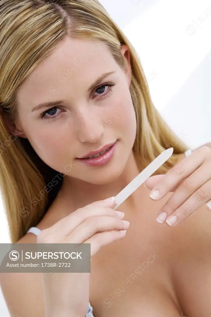 Portrait of a young woman smelling her wrist
