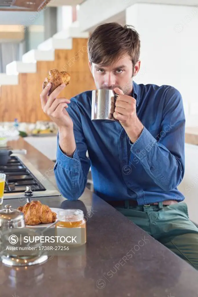 Man having breakfast at a kitchen counter