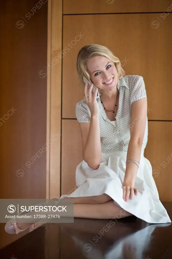 Portrait of a woman talking on a mobile phone and smiling