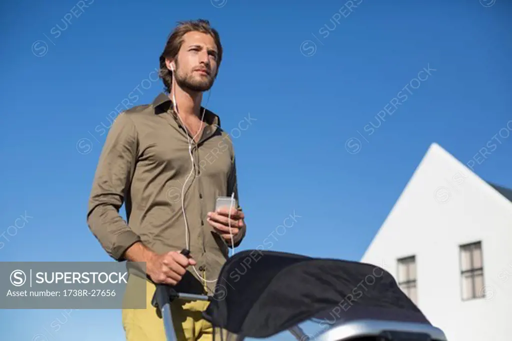 Man standing with a baby stroller