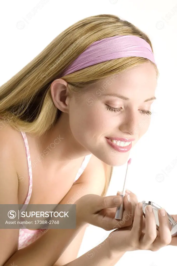 Portrait of a young woman looking at the camera, make-up, close-up, indoors studio