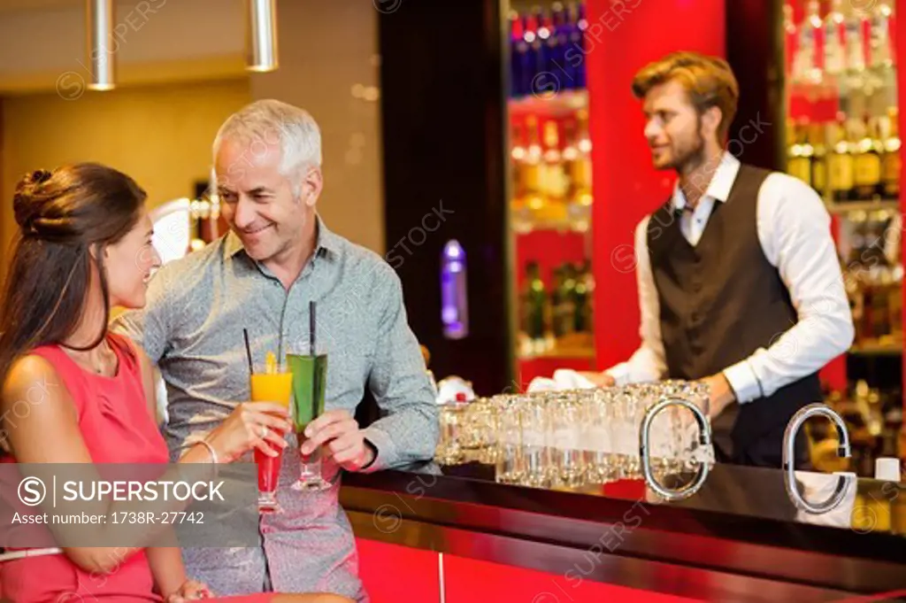 Couple enjoying drinks at the bar counter