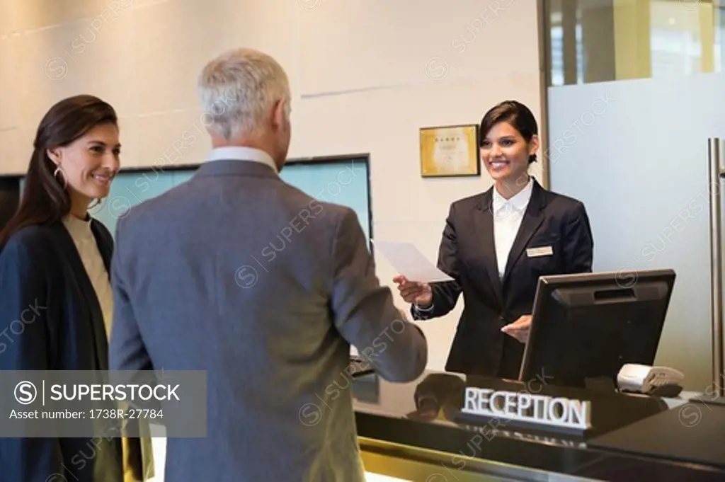 Business couple checking into hotel