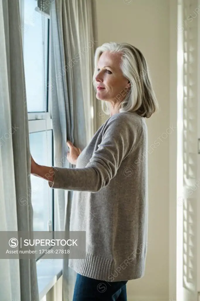Woman standing by a window