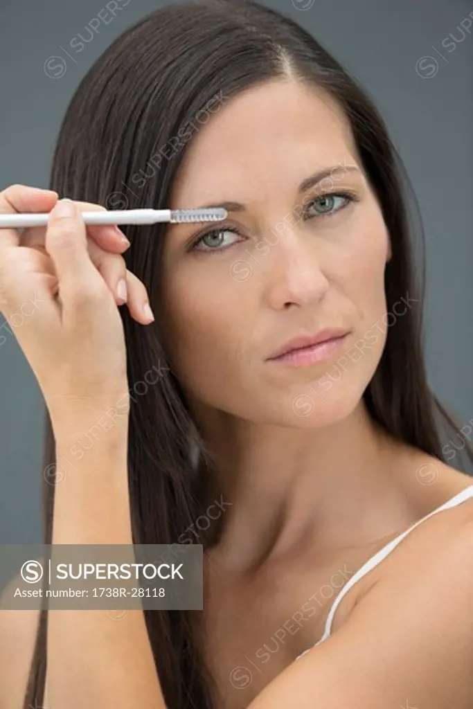 Portrait of a woman applying eyeliner