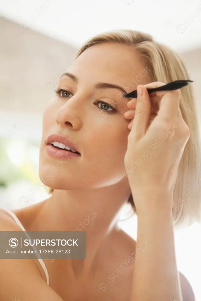 Woman tweezing her eyebrows