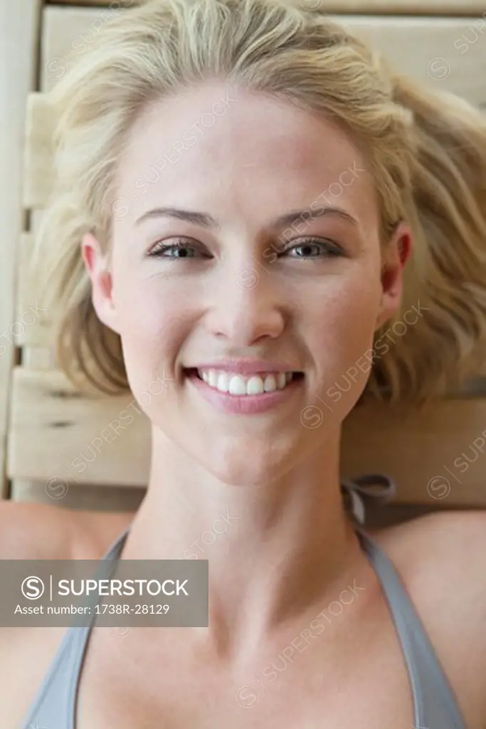 Portrait of a smiling woman resting in a sauna