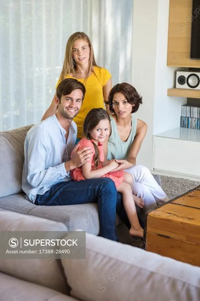 Parents with their children sitting in a living room