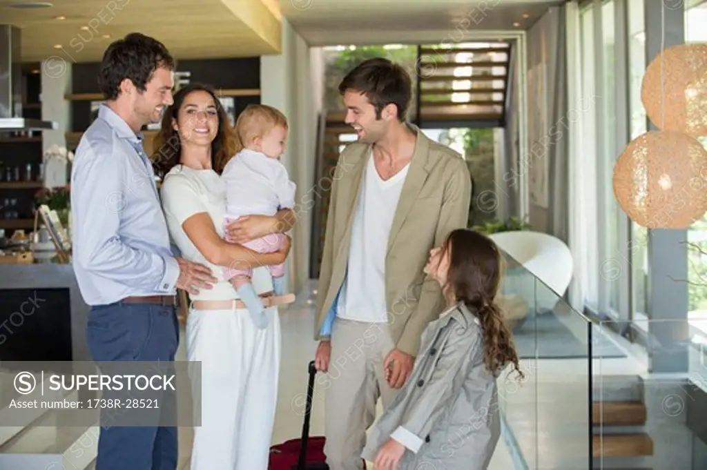 Man with his daughter arriving from holiday at his friends home