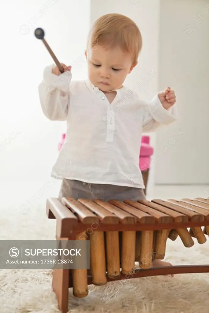 Baby boy playing a xylophone