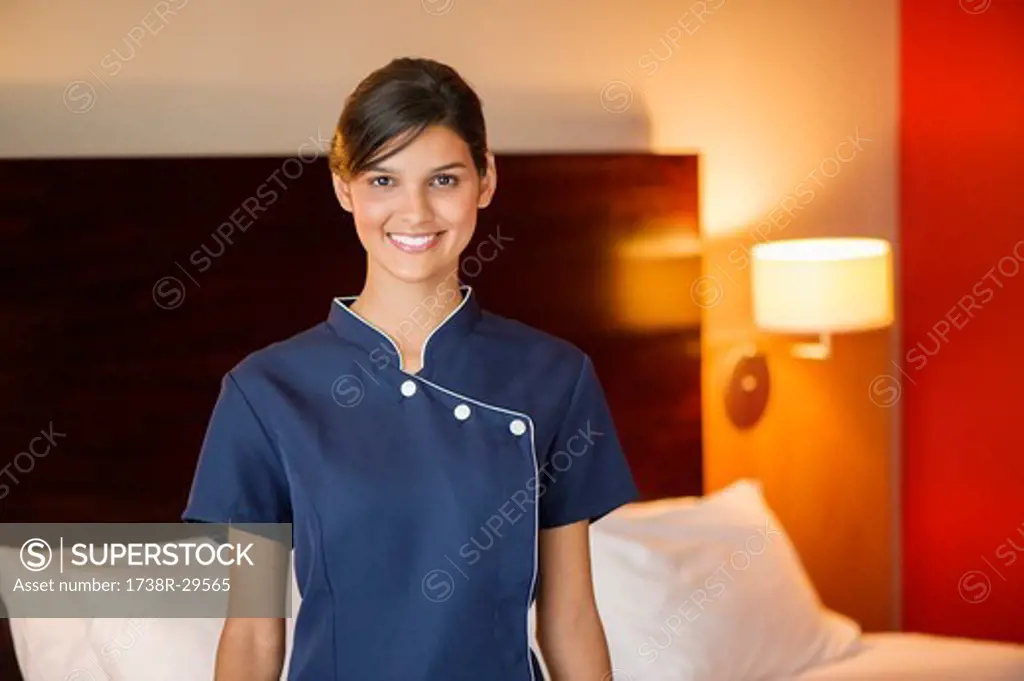 Portrait of a maid smiling in a hotel room