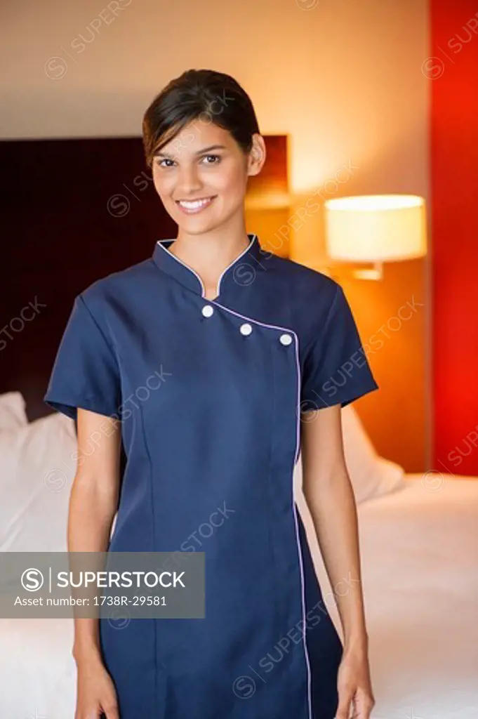 Portrait of a maid smiling in a hotel room