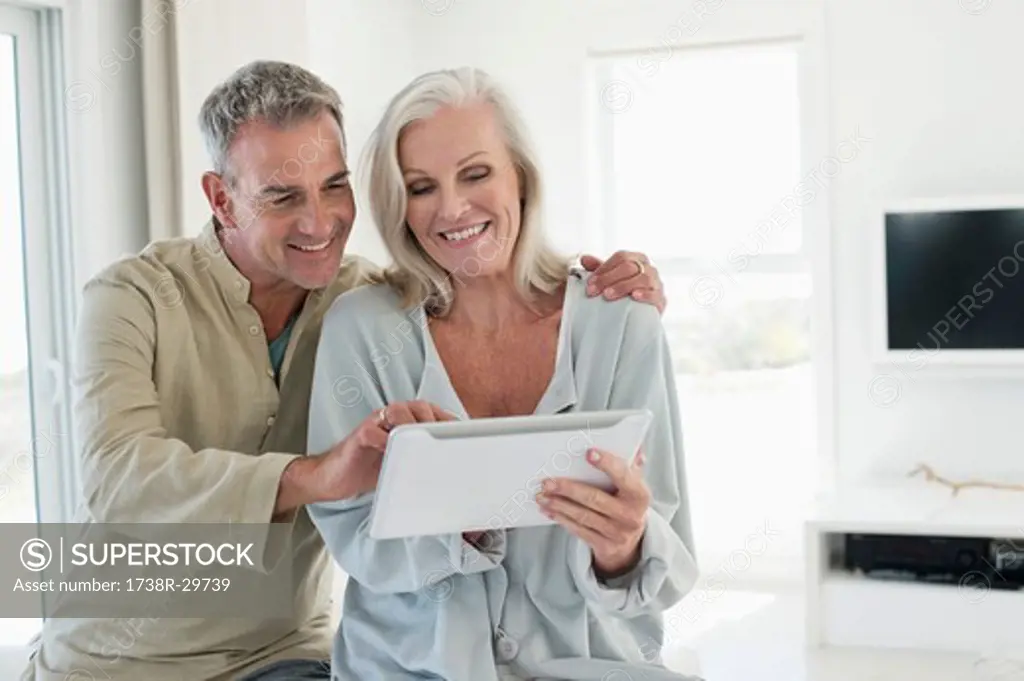 Smiling senior couple using a digital tablet