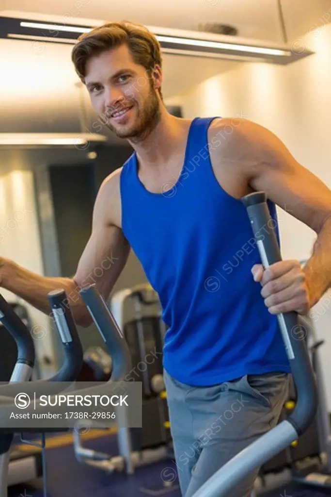 Portrait of a smiling man exercising in a gym