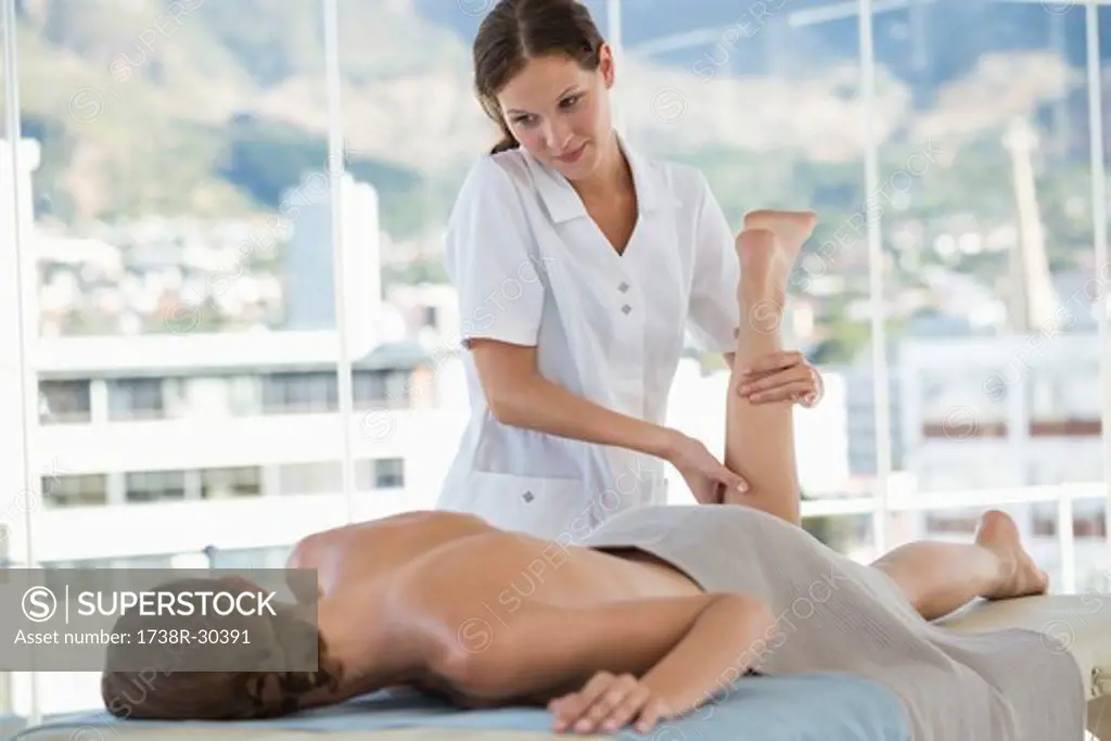 Woman receiving leg massage from a massage therapist