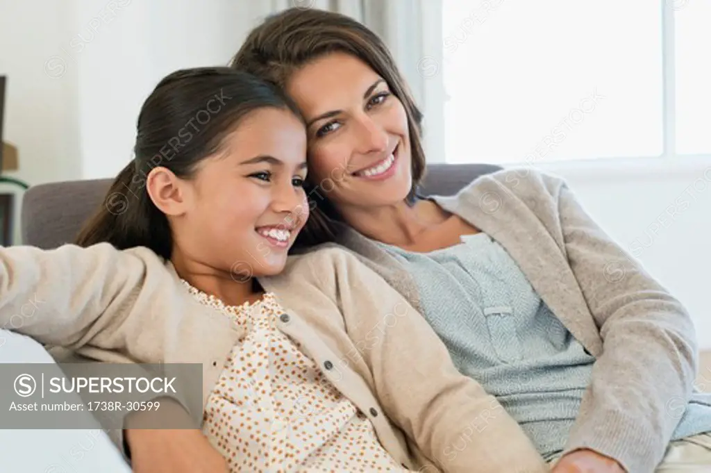 Portrait of a woman and her daughter smiling