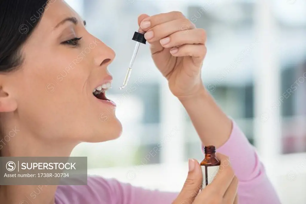 Close-up of a woman taking homeopathic medicine